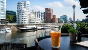 Medienhafen waterfront in Düsseldorf, Germany with a café terrace and paper straw