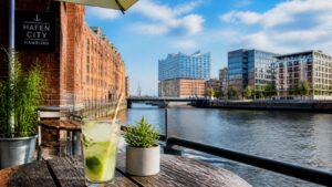 Waterfront cafe terrace in HafenCity, Hamburg, Germany with a drink and paper straw