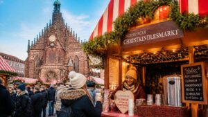 Nuremberg Christkindlesmarkt in Germany with traditional wooden stalls and paper straws